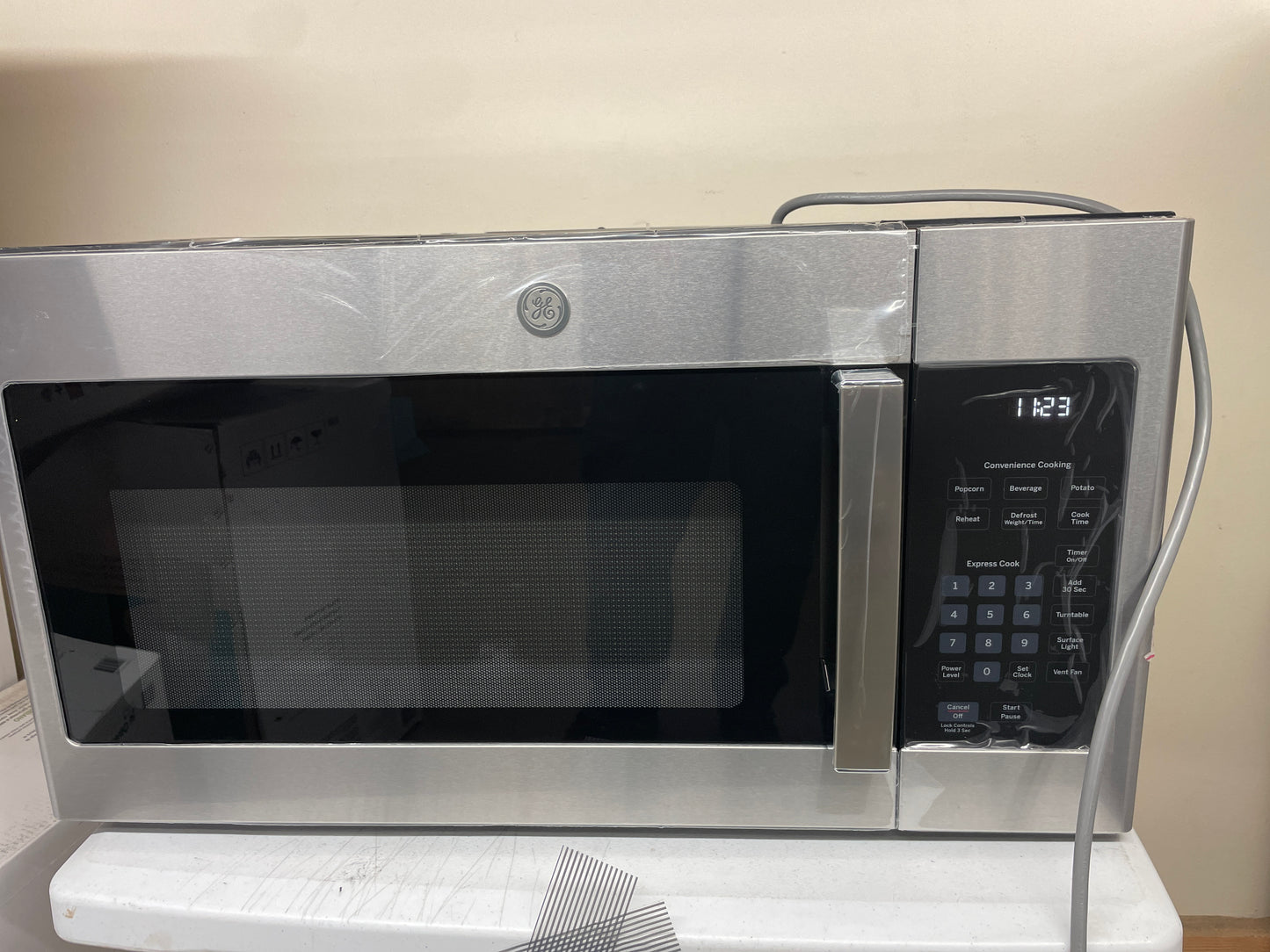 GE 1.6 cu. ft. Over-the-Range Microwave Oven with Cooktop Lighting and 300-CFM Exhaust Fan JVM3160RFSS - Retail $359