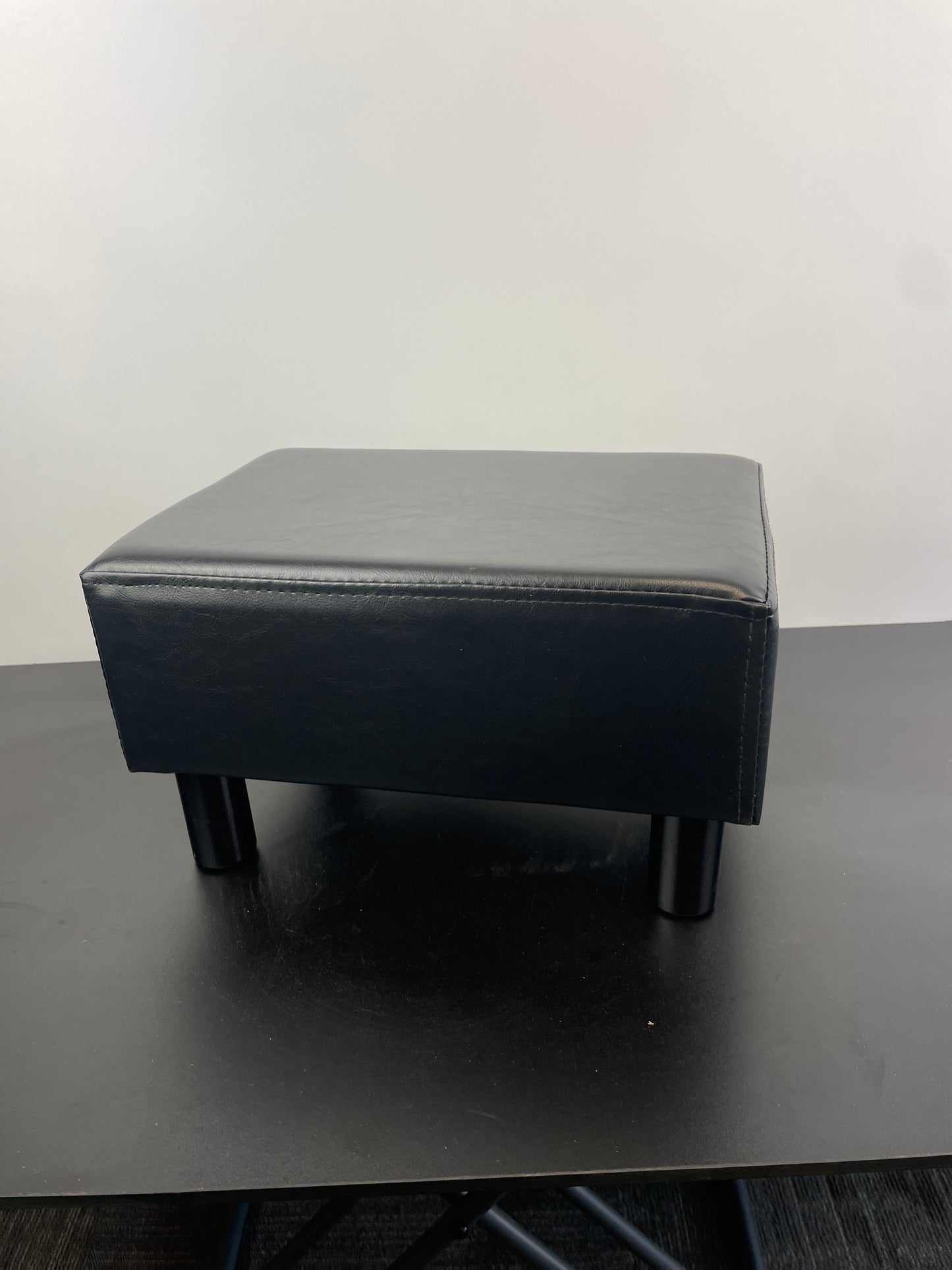 YOUDENOVA 16 inches Footstool Ottoman with 4 Stable Wooden Legs, Small Under Desk Footrest, Black PU Faux Leather Step Stool with Padded Seat for Living Room Bedroom - Retail $35