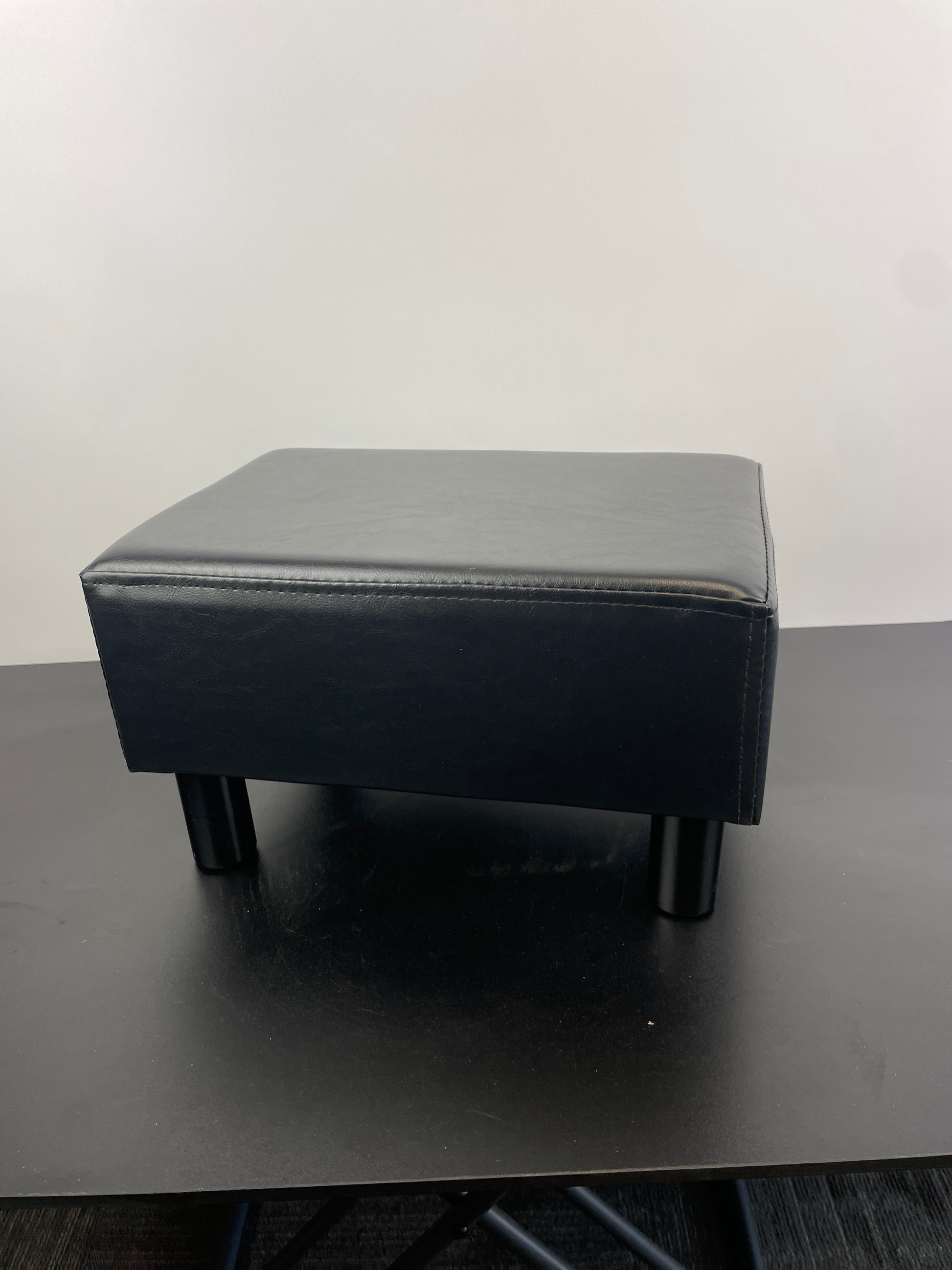 YOUDENOVA 16 inches Footstool Ottoman with 4 Stable Wooden Legs, Small Under Desk Footrest, Black PU Faux Leather Step Stool with Padded Seat for Living Room Bedroom - Retail $35